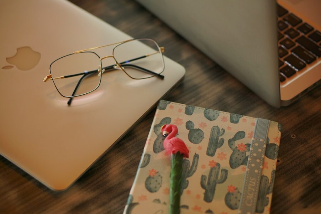 black framed eyeglasses on white laptop computer