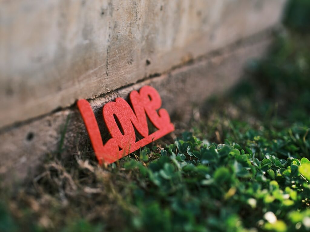 a red sign that is on the side of a wall
